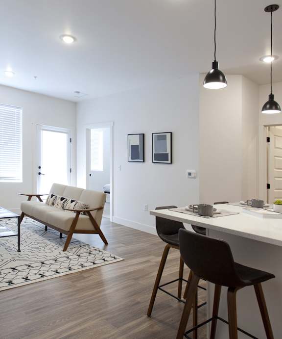 A top down view of a small apartment with a kitchen, living room, and bathroom.