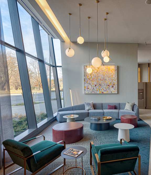 A modern living room with a large window and a long hallway.