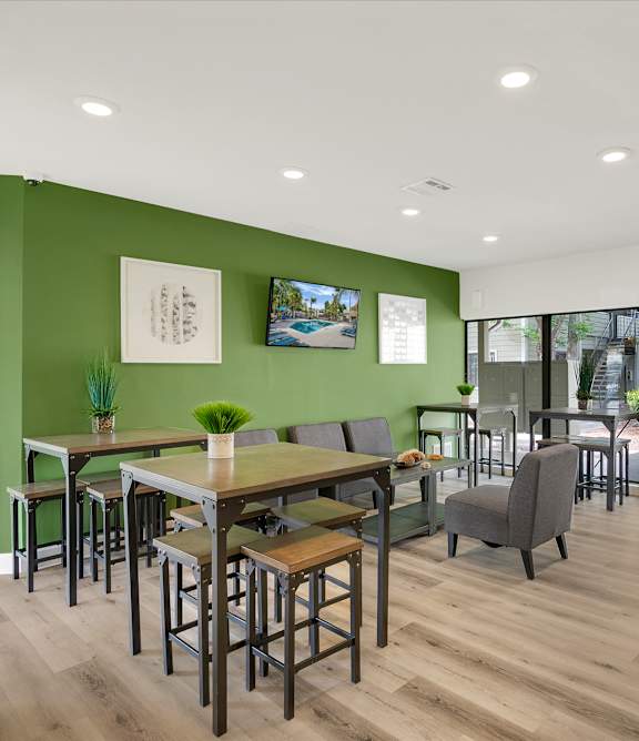 A room with a green wall and a wooden floor.