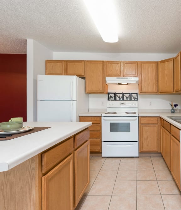 Bismarck, ND Sierra Ridge |a kitchen with white appliances and wooden cabinets Bismarck, ND Sierra Ridge |a kitchen with white appliances and wooden cabinets