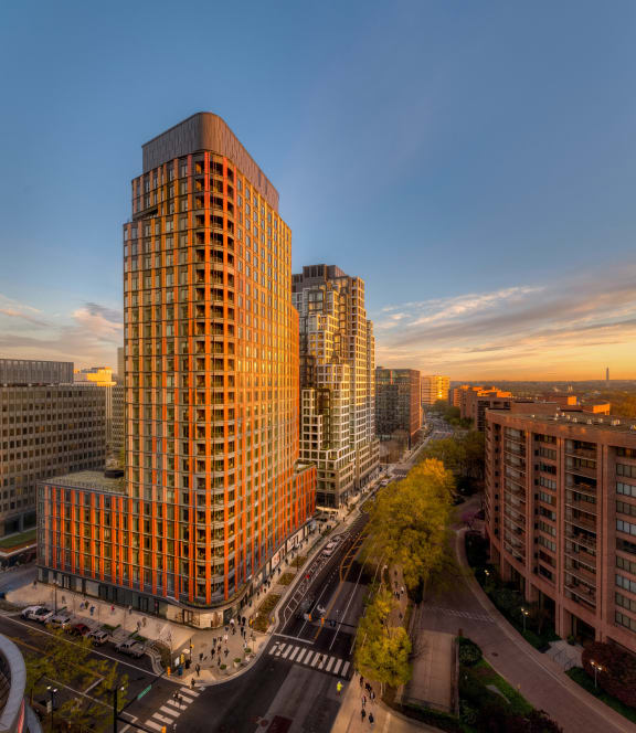 a sunset view of skyscrapers in the city