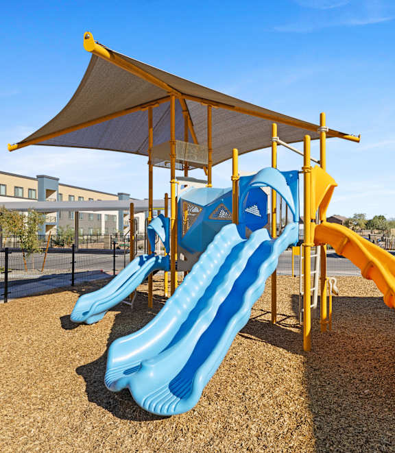 a playground with slides and a tent at Agave House Apartments, Casa Grande, 85122