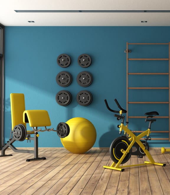 a home gym with a yellow exercise bike and yellow weights