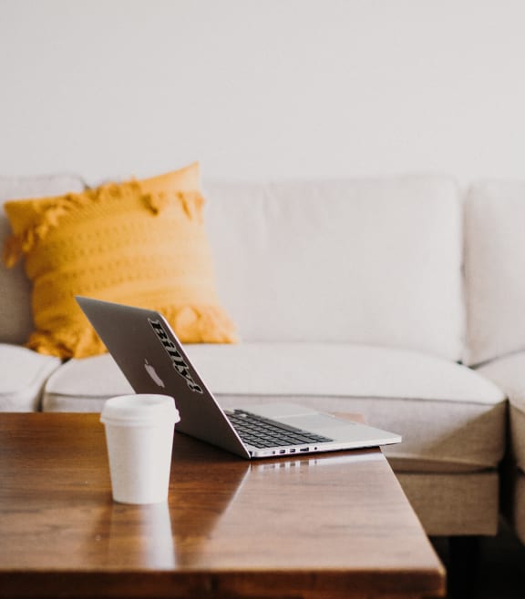 a laptop on a coffee table in a living room