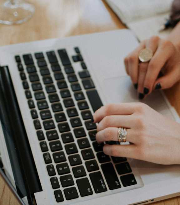 A person is typing on a laptop keyboard.