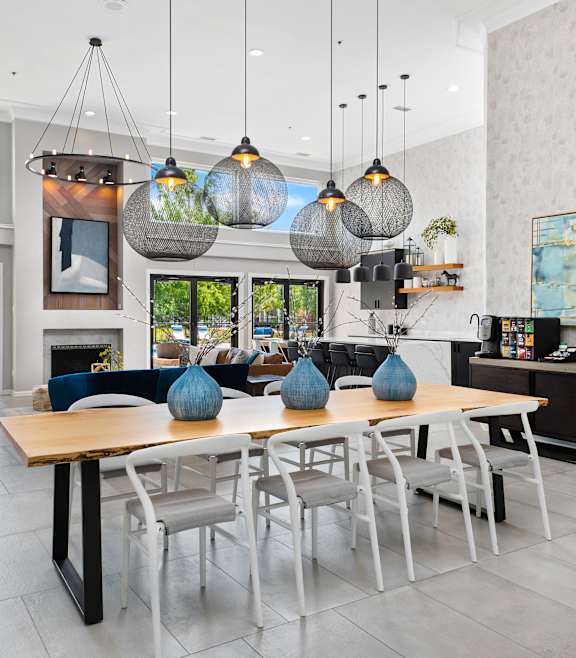 A modern dining room with a wooden table and chairs.