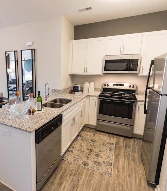 A kitchen with a dining table and chairs.