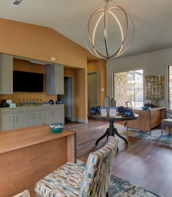 A living room with a wooden floor and a large window.