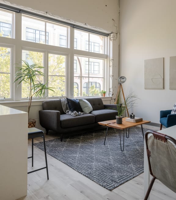 a living room with a large window and a couch