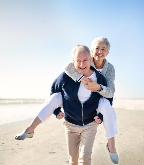 an older couple walking on the beach with a woman holding a man at Oak Grove at Blake Farm, North Carolina, 28411
