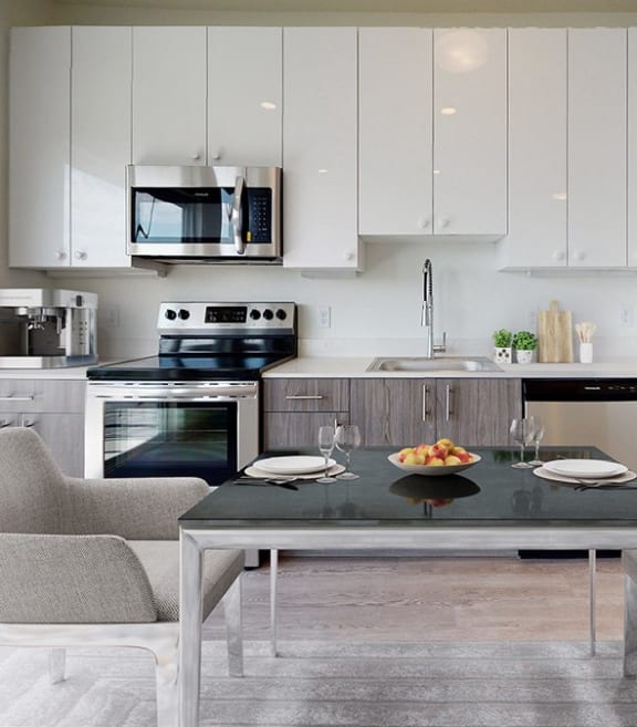 a kitchen with white cabinets and stainless steel appliances
