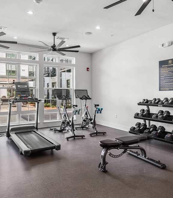 A gym with treadmills, exercise bikes, and weights. at The Quarter Lofts Apartments, Mississippi, 39216