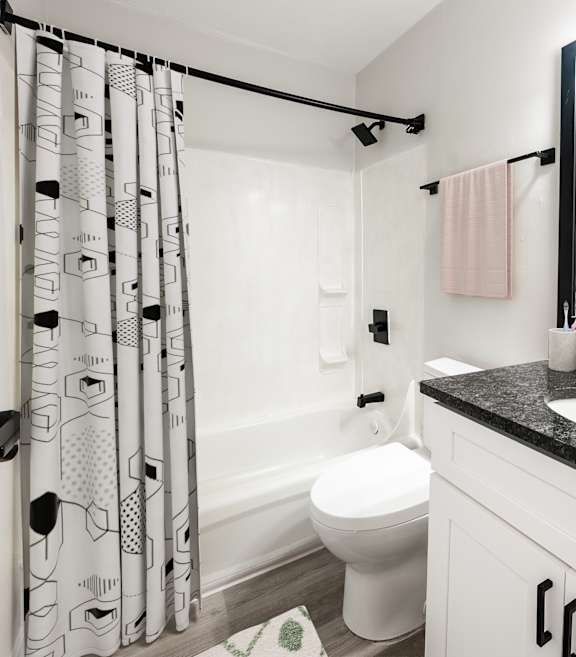 A bathroom with a black and white shower curtain.