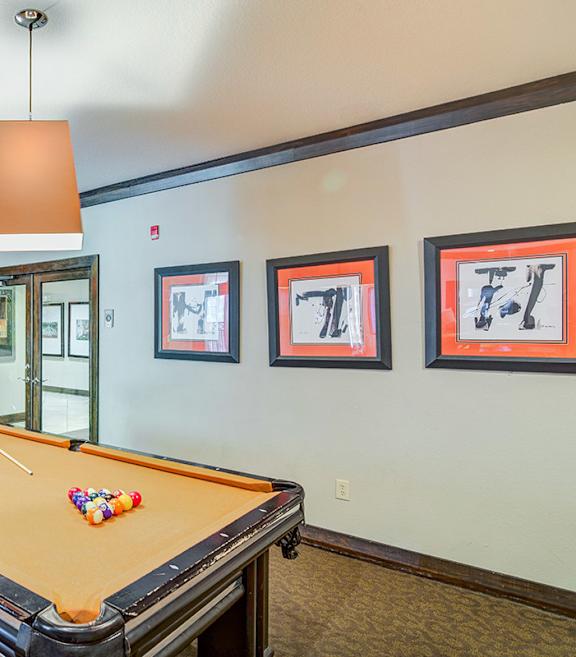 A pool table with a white ball on it.