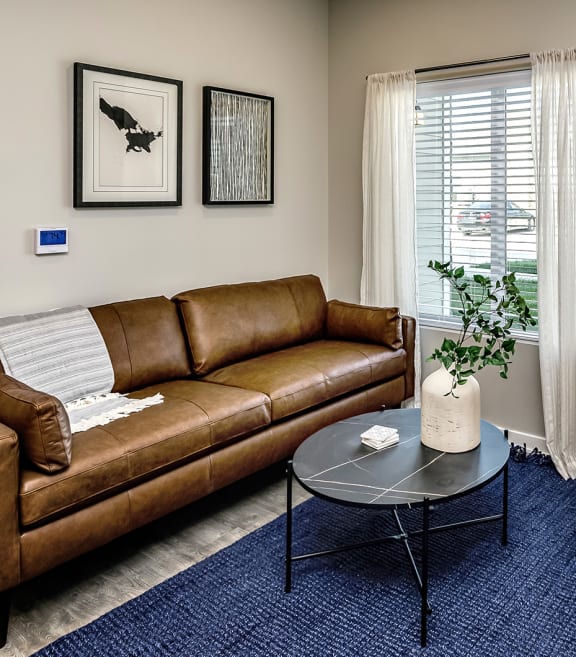 a living room with a couch chair and coffee table