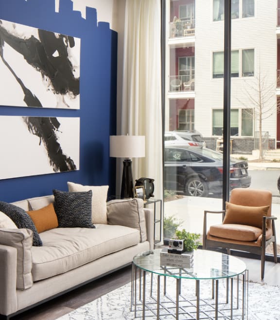 a living room with a large blue and white painting on the wall