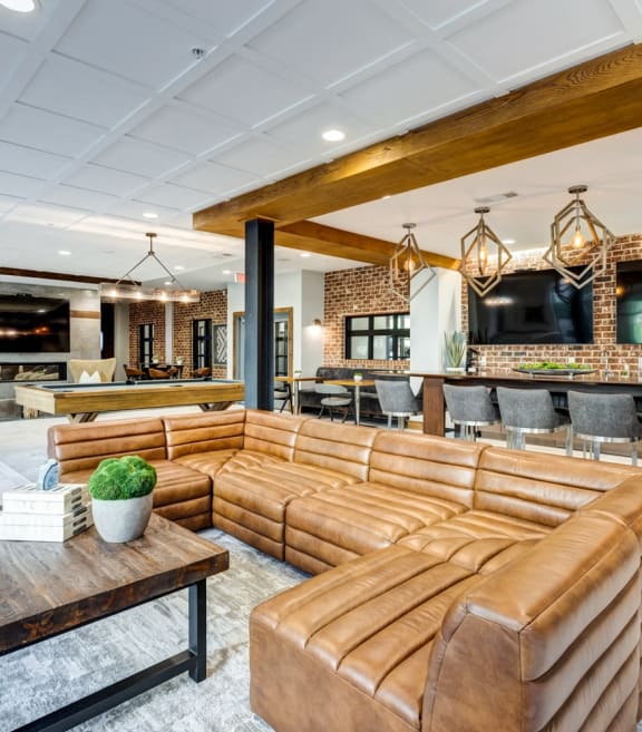 the lobby of a hotel with couches and a bar