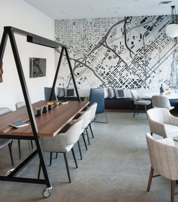 a room with a table and chairs and a large mural on the wall