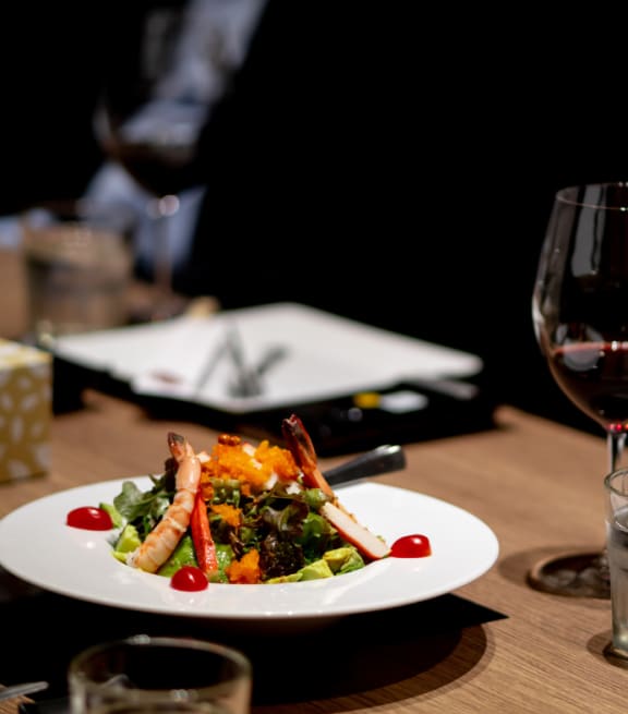 a plate of food and a glass of water on a table