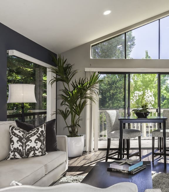 a living room with a couch and a table and a large window