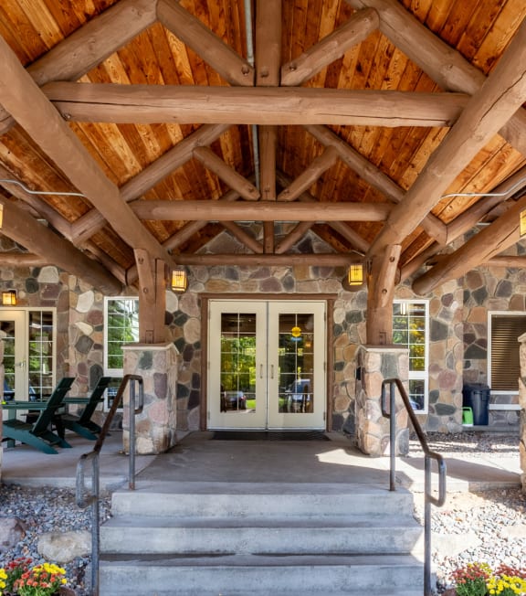 the front door of a house with stairs and a porch