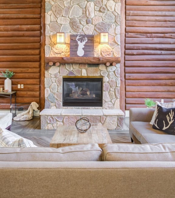 a living room with a stone fireplace and a couch
