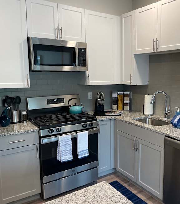 A kitchen with a stove, microwave, and dishwasher.