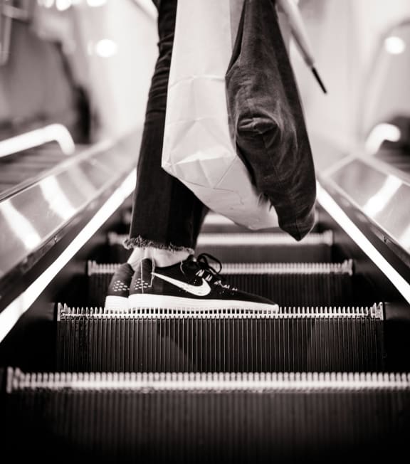 a person with a bag walking down an escalator a person with a bag walking down an escalator at Cycle Apartments, Colorado, 80525