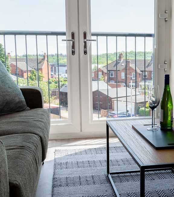 A modern house with a grey front and a green door at The Foundry Apartments, Bordon