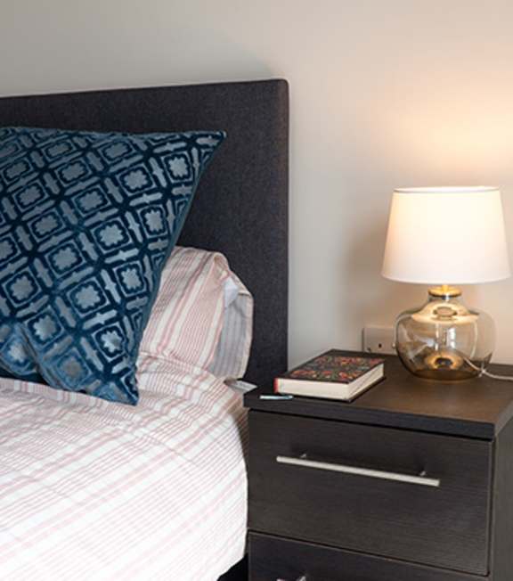 a living room with a couch and a table at The Foundry Apartments, Bordon, GU35 9FE