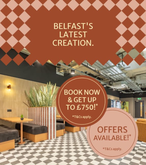 A room with a table and chairs and a sign that says Biscuit Factory.