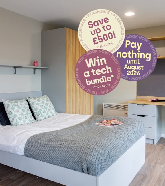 A bedroom with a bed, a desk, and a sign offering a discount on a Warwick University bus pass.