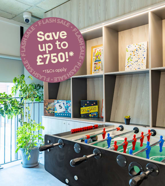 A laundry voucher for £350 is advertised on a circular sign in a room with tables and chairs.