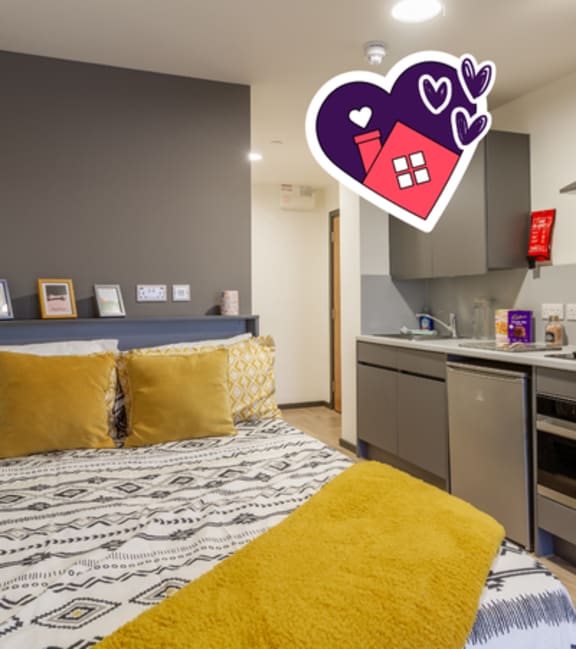 A bedroom with a bed and a kitchen area.