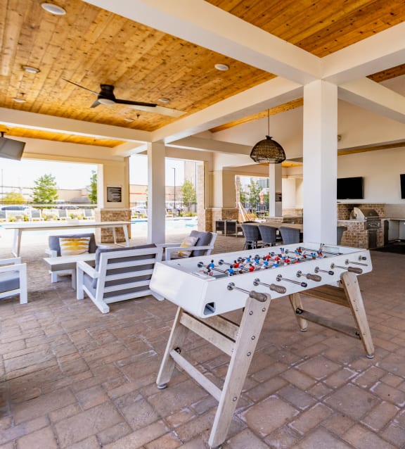 a large covered patio with a foosball table