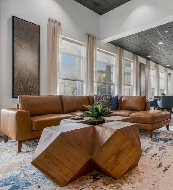 a lobby with couches and a table on a rug at CityView, Missouri, 64116