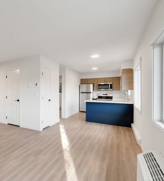 an empty living room and kitchen in a new home