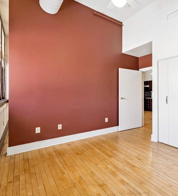 a bedroom with a large bed and a ceiling fan