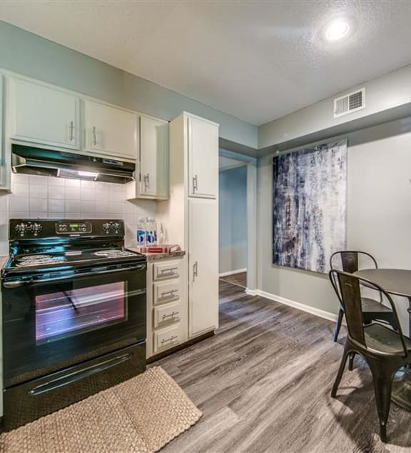 a kitchen with a countertop and a sink  at London House Apartments, Kansas
