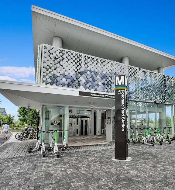 A modern building with a white roof and a black and white tiled wall.