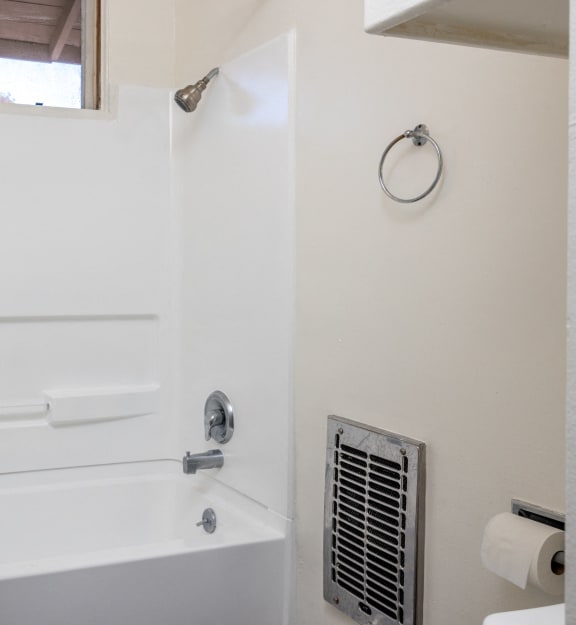 a bathroom with a sink and a tub and a window