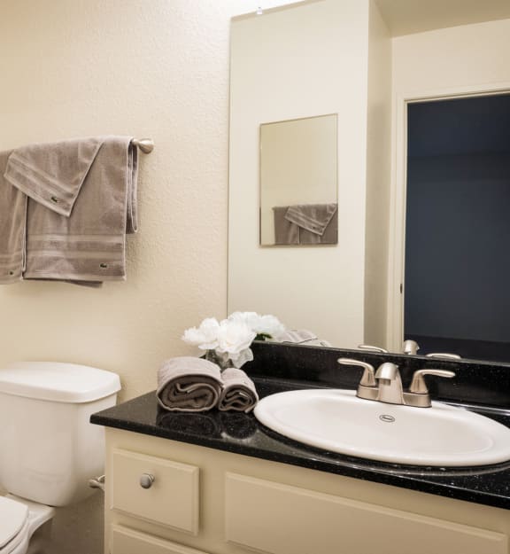 a bathroom with a toilet sink and shower