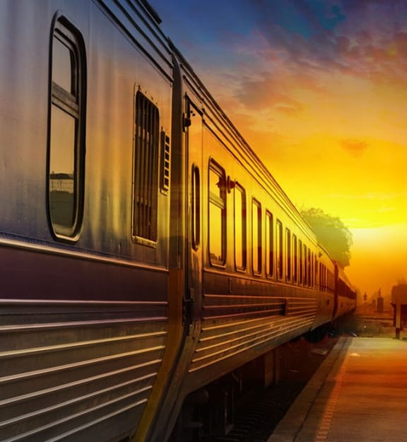a train at a train station at sunset at The Rail at Red Bank, New Jersey