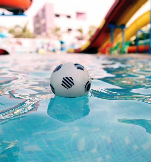 A soccer ball floating in a pool of water.