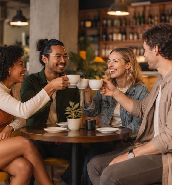 Four people are sitting around a table in a restaurant.