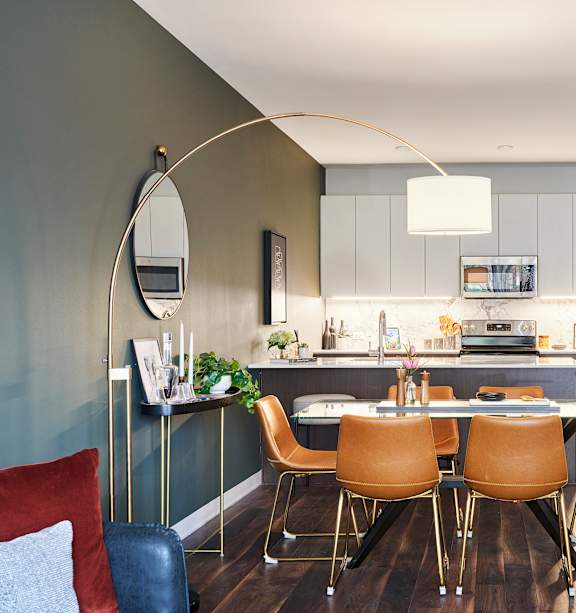 A modern kitchen with a dining table and chairs.