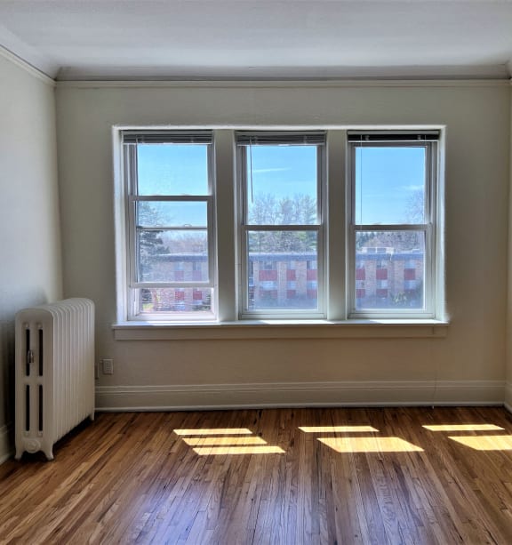 the living room of an empty house with sunlight coming through the windows