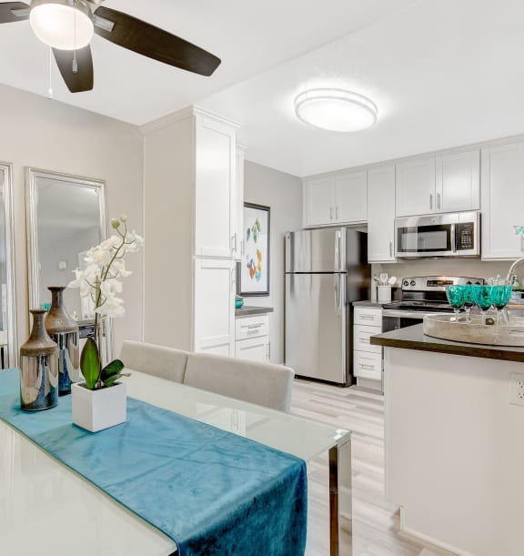 a living room with a dining room table and a kitchen