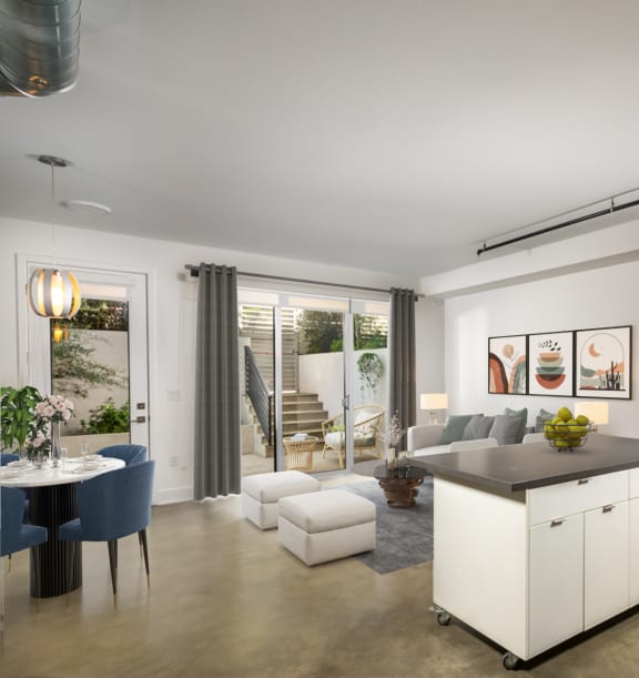 a kitchen and living room with white cabinetry and a counter top in a house