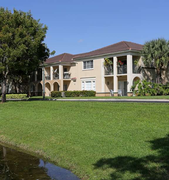 A building with a pond in front of it.